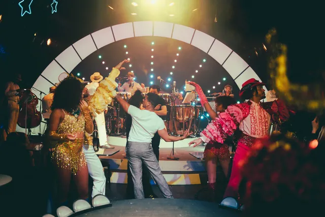 Dancers and orchestra on the Paradise Under the Stars stage, under an arch of lights